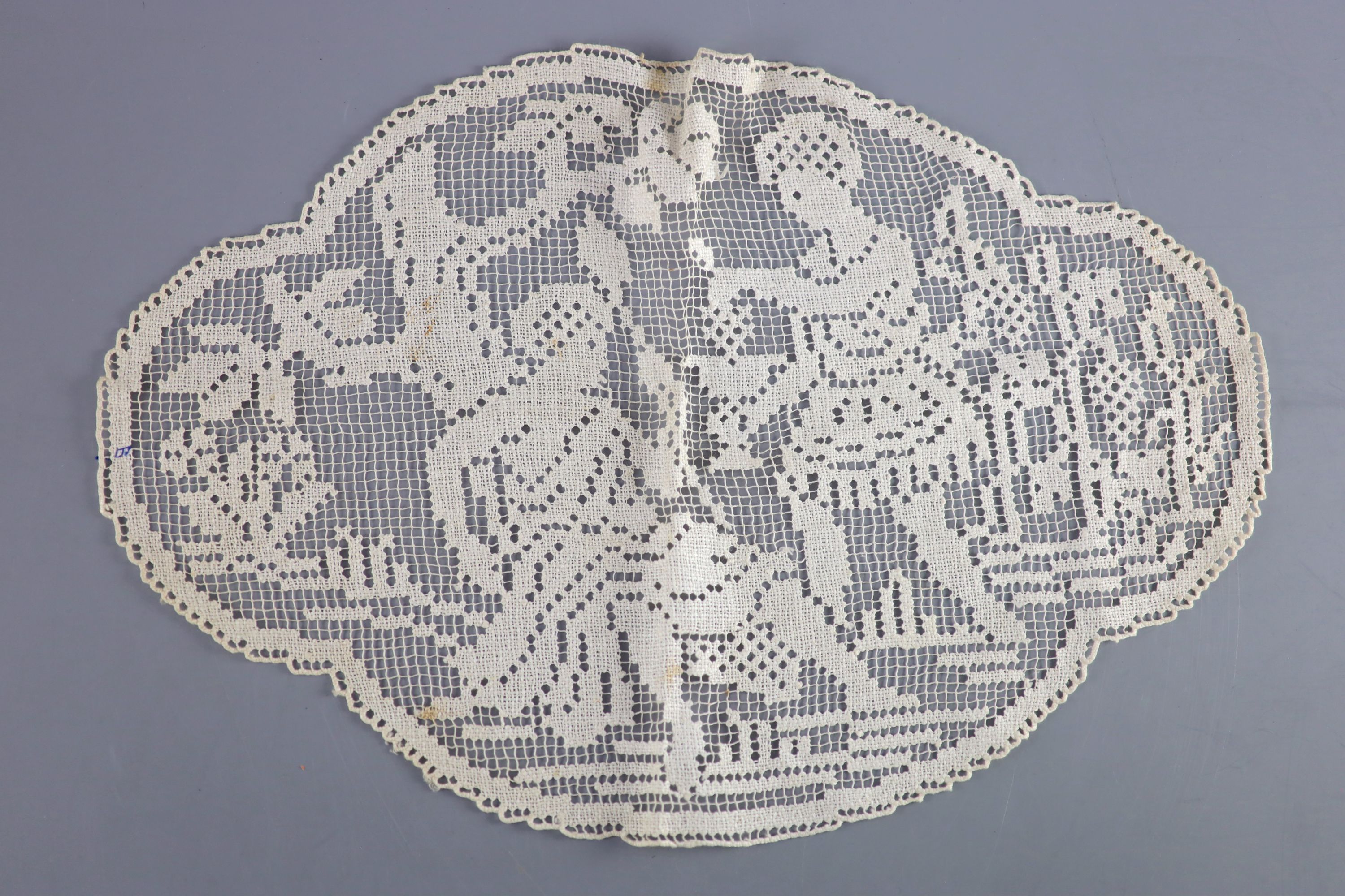 A fine white worked embroidered lace inset coverlet, a filet lace square of a figure wearing a crown (plus museum note),